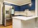 This spacious kitchen has blue cabinets, modern stainless steel appliances, and a stylish island at 505 Commander Dr, Wendell, NC 27591