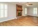 Comfortable living room featuring a brick fireplace and ample natural light from shuttered windows at 505 Commander Dr, Wendell, NC 27591