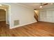 Bright living room featuring wood-style floors, built-in shelving, and a classic ceiling fan at 505 Commander Dr, Wendell, NC 27591