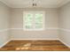 Bright living room with hardwood floors, ceiling fan, natural light from the windows at 505 Commander Dr, Wendell, NC 27591