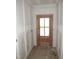 Entryway featuring a solid wood front door, framed by bright white walls with clean trim work at 53 Stonewood Loop Ln, Henderson, NC 27537