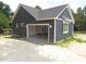 Exterior view of a home with an attached garage, showcasing fresh paint and simple design at 53 Stonewood Loop Ln, Henderson, NC 27537