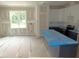 Spacious kitchen with dark counters and white cabinets, awaiting finishing touches in a sunlit space at 53 Stonewood Loop Ln, Henderson, NC 27537