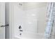 Bright bathtub/shower combo features a fresh white tile surround and decorative shower curtain at 544 Tanner Lake Ln, Raleigh, NC 27610