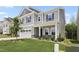 Gray two-story home with stone accents and manicured lawn shows curb appeal and modern design at 544 Tanner Lake Ln, Raleigh, NC 27610