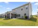Exterior view of home highlighting the screened porch and the backyard's landscape at 544 Tanner Lake Ln, Raleigh, NC 27610