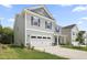 Beautiful two-story home with a two car garage, well-maintained lawn, and a modern design at 544 Tanner Lake Ln, Raleigh, NC 27610