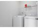 Convenient laundry area with a washer, dryer, and overhead shelving for storage at 544 Tanner Lake Ln, Raleigh, NC 27610