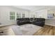 Spacious living area with large sofa, decorative rug, and views of the kitchen and backyard beyond at 544 Tanner Lake Ln, Raleigh, NC 27610