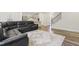 Open concept living space with a large sofa, stairs, and modern design creating an inviting atmosphere at 544 Tanner Lake Ln, Raleigh, NC 27610