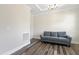 Well-lit living room with hardwood floors, crown molding, and a comfortable sofa for relaxing and entertaining at 544 Tanner Lake Ln, Raleigh, NC 27610