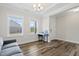 Bright living room with hardwood floors, natural light, and a view of the neighborhood through windows at 544 Tanner Lake Ln, Raleigh, NC 27610