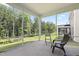 Screened porch with a view of the spacious backyard and wooded area beyond at 544 Tanner Lake Ln, Raleigh, NC 27610
