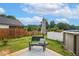 Backyard with a black iron bench, umbrella, above ground pool, and fenced perimeter at 553 Sturgeon St, Smithfield, NC 27577