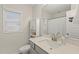 Bright bathroom with white cabinets, quartz countertop, single sink and blind-covered window at 553 Sturgeon St, Smithfield, NC 27577