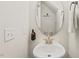 Powder room with a pedestal sink, oval mirror, and modern fixtures at 553 Sturgeon St, Smithfield, NC 27577