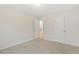 Bright bedroom featuring carpet, a double door closet, and access to an adjacent hallway at 553 Sturgeon St, Smithfield, NC 27577