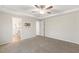Bright, carpeted bedroom with ceiling fan, adjacent bathroom, and TV wall mount at 553 Sturgeon St, Smithfield, NC 27577