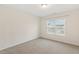 A bright bedroom with neutral walls, carpet, and natural light from a window at 553 Sturgeon St, Smithfield, NC 27577