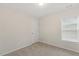 Neutral bedroom with plush carpet, window with blinds, and ceiling light fixture at 553 Sturgeon St, Smithfield, NC 27577