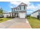 Charming two-story home with an attached garage, covered porch, and manicured lawn at 553 Sturgeon St, Smithfield, NC 27577