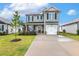 View of a two-story home featuring light gray siding, a front porch, and a concrete driveway at 553 Sturgeon St, Smithfield, NC 27577