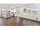 Open-concept kitchen with granite countertops, stainless steel appliances, island seating, and view of large windows at 553 Sturgeon St, Smithfield, NC 27577