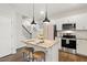 Bright kitchen with granite countertops, an island with seating, and stainless steel appliances at 553 Sturgeon St, Smithfield, NC 27577