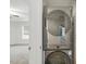 Modern laundry area with a stacked washer and dryer and bedroom in background at 553 Sturgeon St, Smithfield, NC 27577