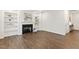 Spacious living room with fireplace and built-in shelving showcasing wood floors, leading to the kitchen at 553 Sturgeon St, Smithfield, NC 27577