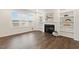 Bright living room featuring a fireplace, built-in shelving, and large windows for natural light at 553 Sturgeon St, Smithfield, NC 27577