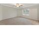 Spacious main bedroom featuring a tray ceiling, neutral carpet, and a bright window at 553 Sturgeon St, Smithfield, NC 27577