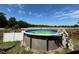 Enjoy the above ground pool surrounded by grass and fencing, ideal for summer fun at 553 Sturgeon St, Smithfield, NC 27577