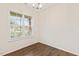 Simple room featuring hardwood floors, a modern light fixture, and a large window at 553 Sturgeon St, Smithfield, NC 27577