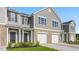 Attractive townhome featuring gray siding, brick base, and attached garages at 5560 Henley Ridge Dr # 187, Graham, NC 27253