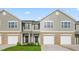 Townhome with gray siding, brick accents, garage, and a well-maintained lawn at 5560 Henley Ridge Dr # 187, Graham, NC 27253