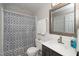 Bathroom features a shower with patterned curtains, updated vanity, and wainscotting at 6016 Farm Gate Rd, Raleigh, NC 27606