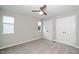 Neutral bedroom featuring a ceiling fan, carpeted floors, and double door closet at 6016 Farm Gate Rd, Raleigh, NC 27606