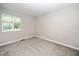 Neutral bedroom featuring a ceiling fan, carpeted floors, and a large window at 6016 Farm Gate Rd, Raleigh, NC 27606