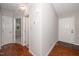 Inviting hallway with hardwood floors, neutral paint, and access to multiple rooms at 6016 Farm Gate Rd, Raleigh, NC 27606