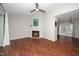 Bright living room featuring hardwood floors, a ceiling fan, and fireplace at 6016 Farm Gate Rd, Raleigh, NC 27606