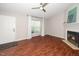 Cozy living room featuring a fireplace, ceiling fan and a large window at 6016 Farm Gate Rd, Raleigh, NC 27606