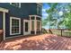 Wood deck and backyard with lush green landscaping on sunny day at 605 Catlin Rd, Cary, NC 27519