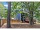 Wide backyard with lush trees and a view of a deck at 605 Catlin Rd, Cary, NC 27519