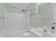 Bright bathroom features a shower and tub combination, with white fixtures at 605 Catlin Rd, Cary, NC 27519