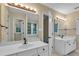 Modern bathroom with double vanity sinks and well lit mirrors at 605 Catlin Rd, Cary, NC 27519