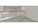 Open landing with neutral carpet and white spindle railing at 605 Catlin Rd, Cary, NC 27519