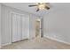 Spacious bedroom with neutral carpet, ceiling fan, and a closet at 605 Catlin Rd, Cary, NC 27519