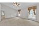 Spacious carpeted bedroom with a ceiling fan, three windows, and neutral-toned walls at 605 Catlin Rd, Cary, NC 27519