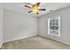 Neutral bedroom with neutral carpet, ceiling fan, and a window at 605 Catlin Rd, Cary, NC 27519